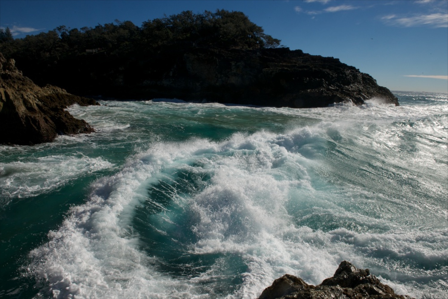 A wave crashes in the shoreline of the second largest sand island in the world- Stradbroke Island, Australia.